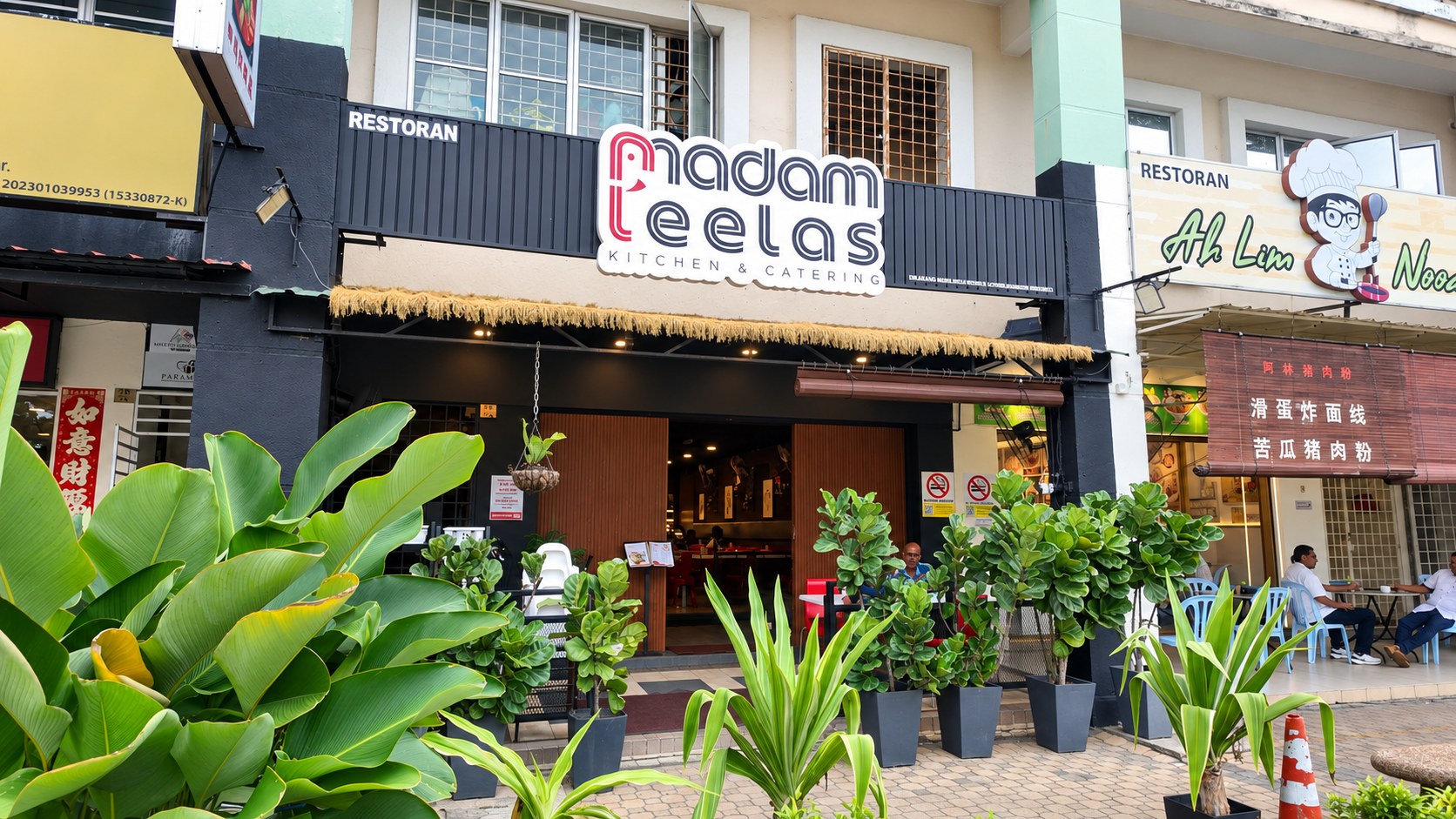 Madam Leela’s restaurant storefront in Kota Kemuning, framed by green plants